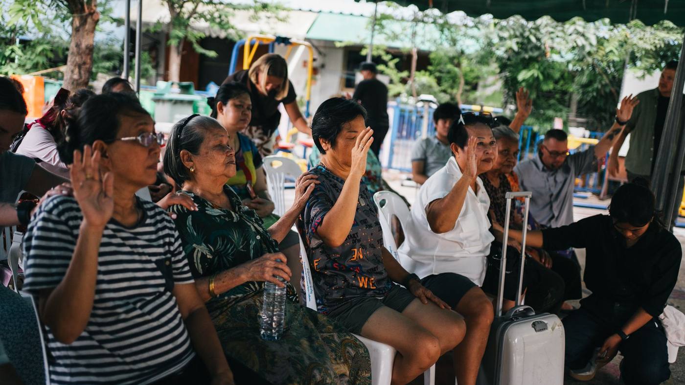 A community gathering in prayer