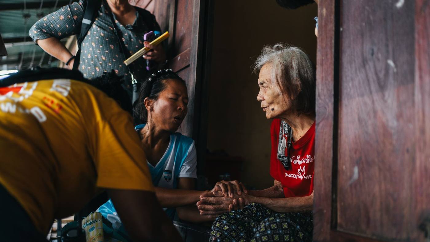 Praying with a grandmother at her door